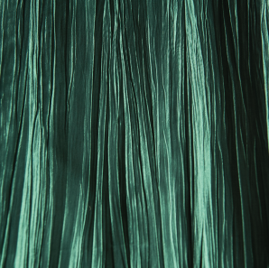 Close up of a forest green crinkled accordion tablecloth.