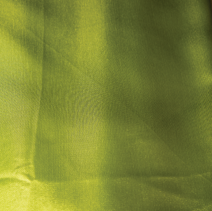Close up of a lime green colored silk tablecloth.