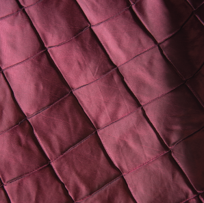 Close up of a purple pin tuck tablecloth
