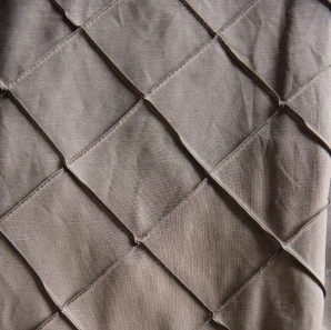 Close up of a silver pin tuck tablecloth.