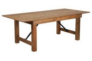 Rustic pine folding farm table in front of a white background.